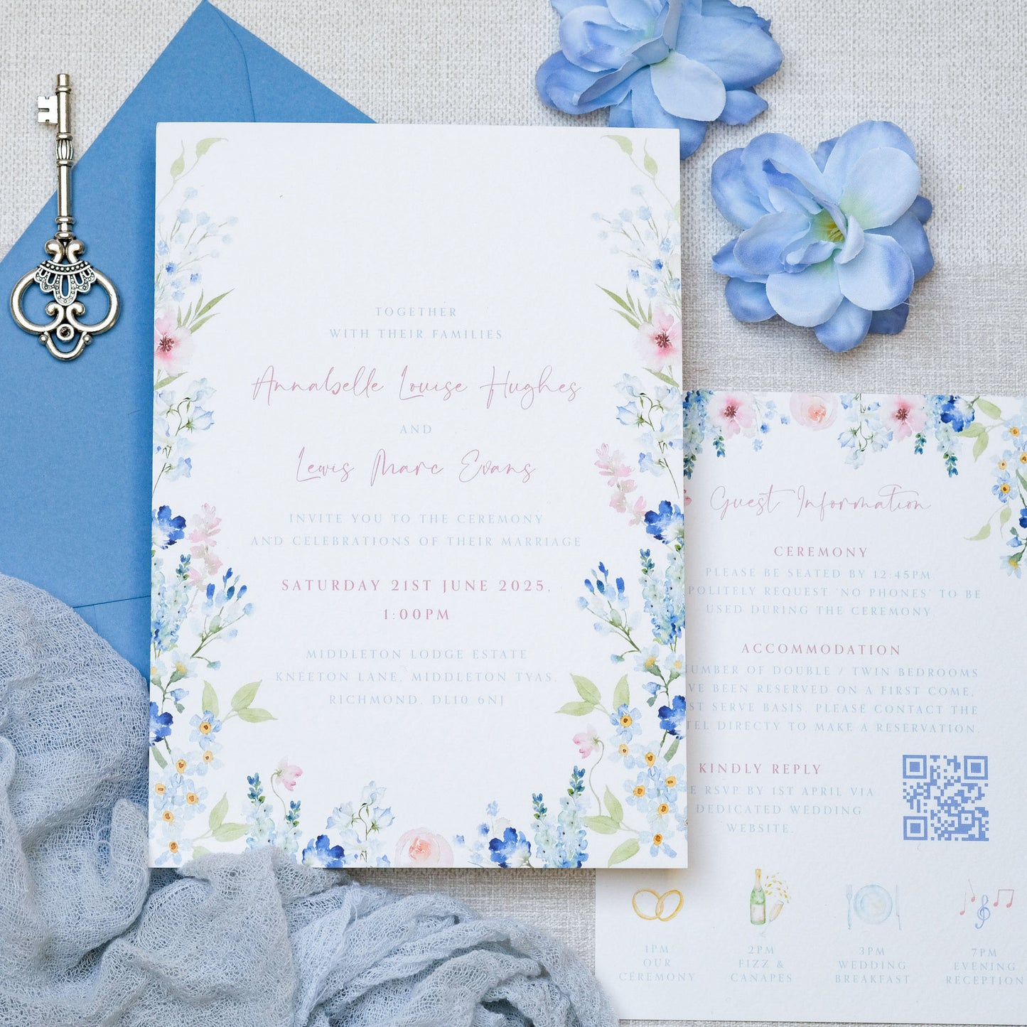 Blue wildflower wedding invitations illustrated, watercolour-style with dusty blue envelope