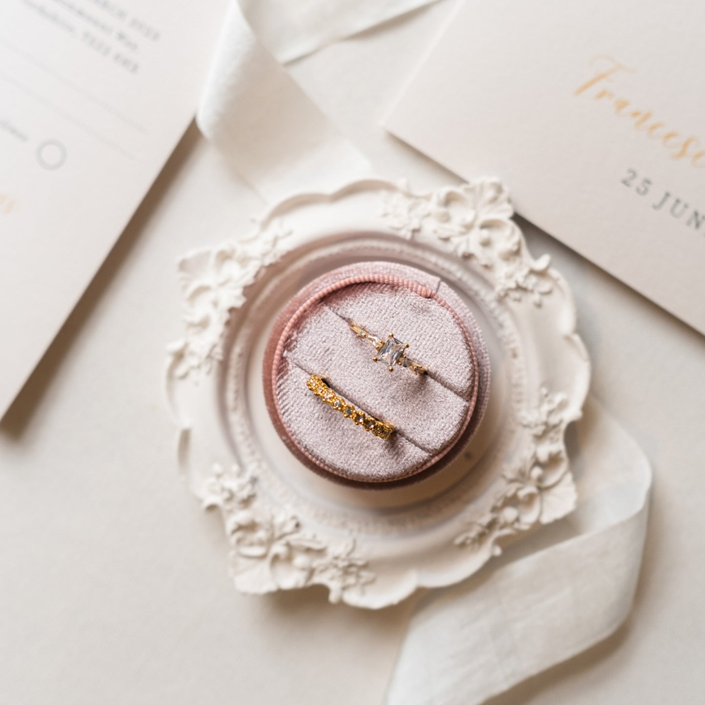 Wedding Rings with Opulent Arch Castle wedding invitations in background