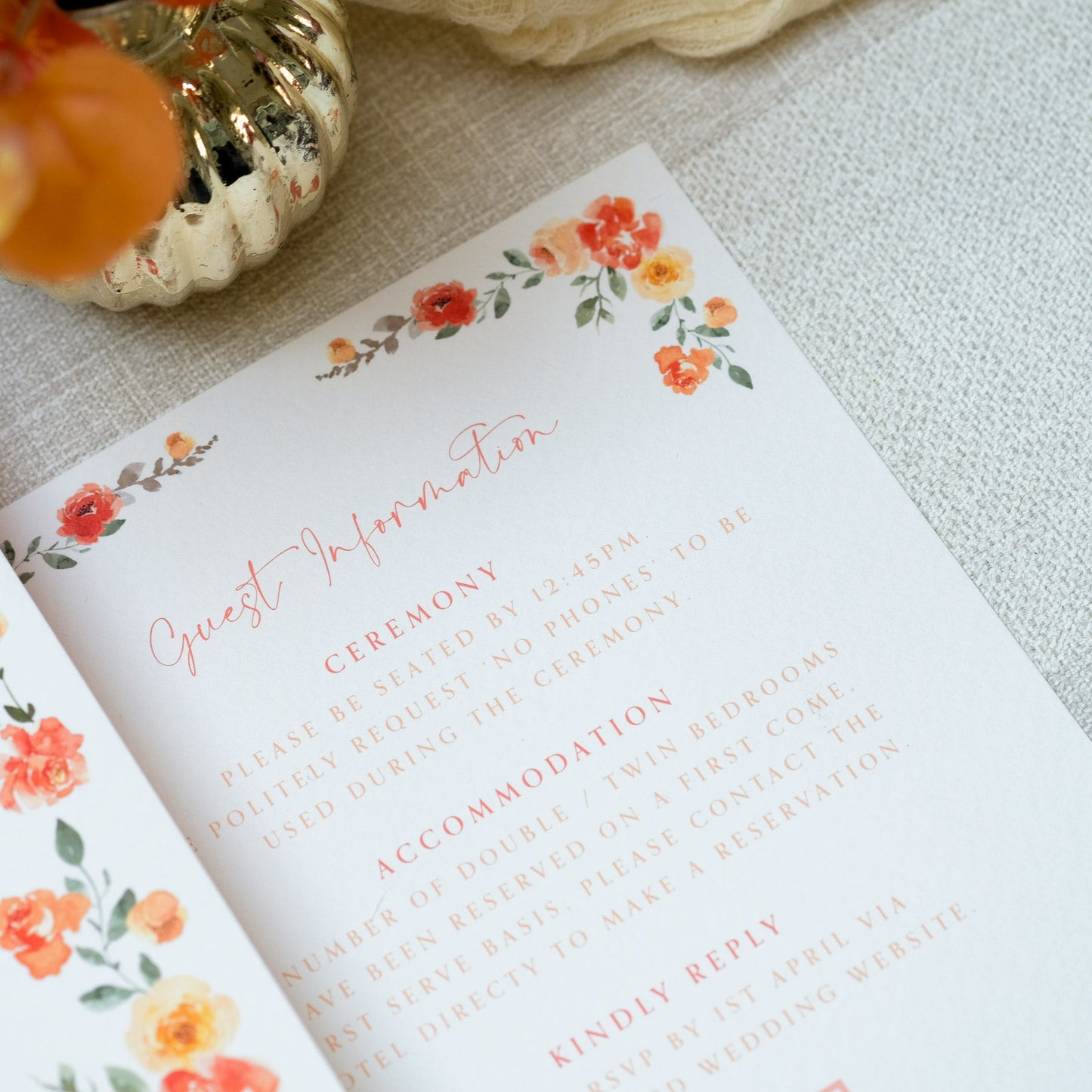 Semi custom wedding invitation with orange wildflower border and wedding information: ceremony, accommodation, and RSVP