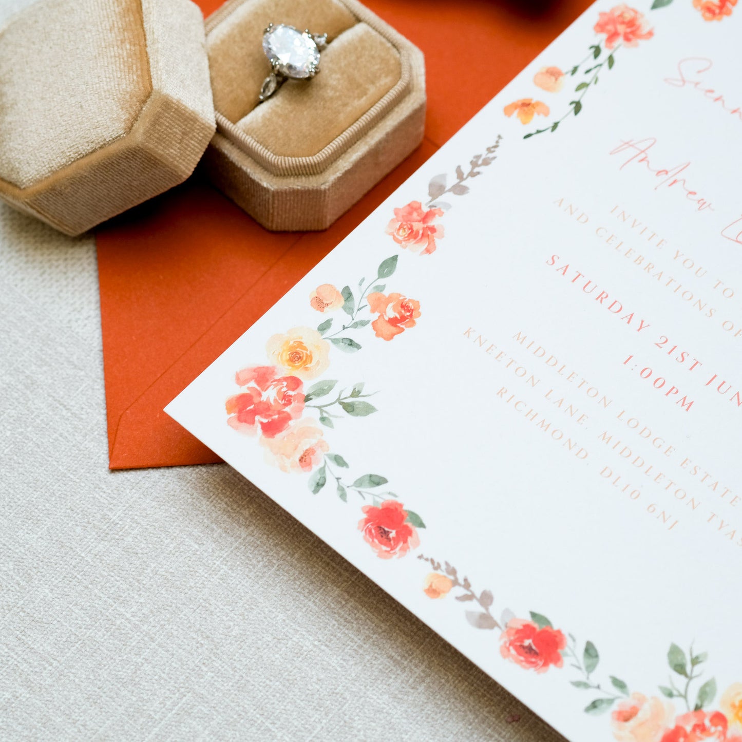 Wedding invitation with orange floral border in painterly style