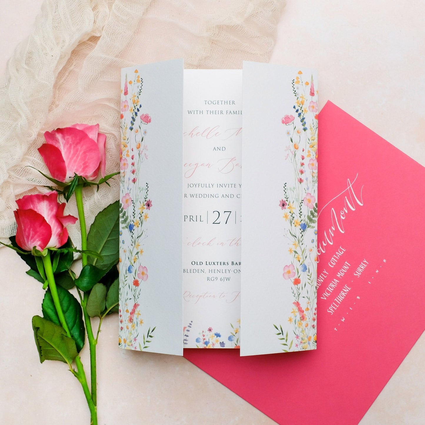 Folded wedding invitation with wildflowers in bright colours, pink yellow purple and blue