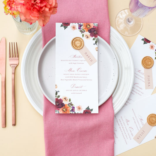 wedding menu with guest name keepsake and burgundy, burnt orange and earthy neutral florals