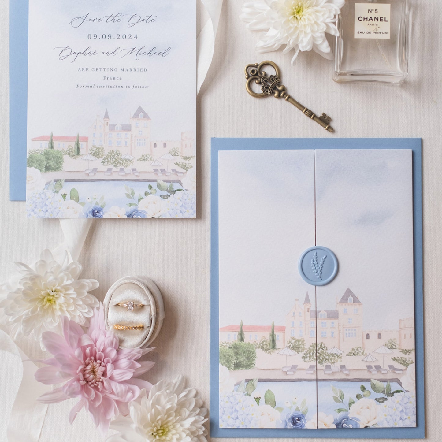 Blue chateau folded wedding invitation with custom venue illustration and wax seal