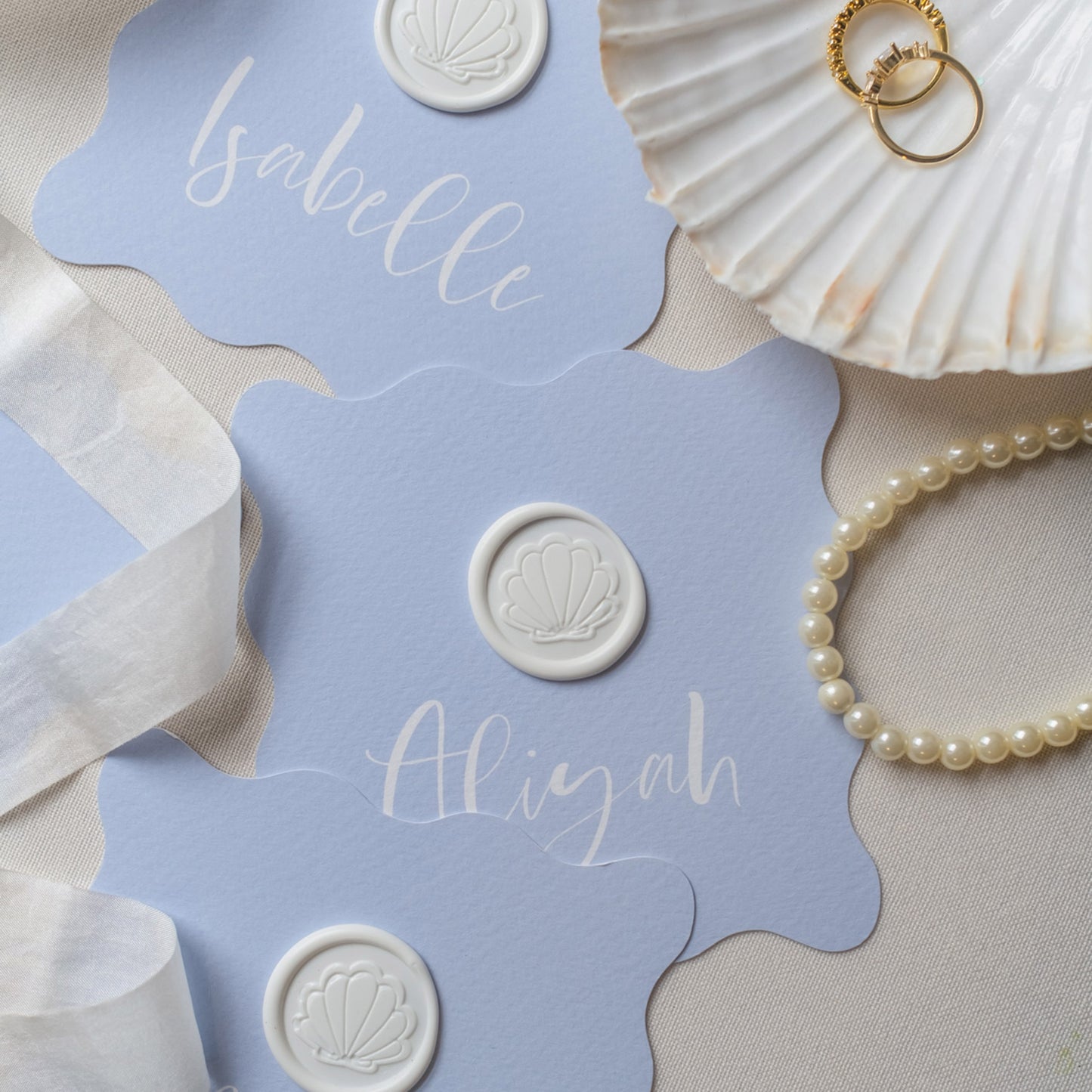 Wavy shaped place cards with shell wax seal