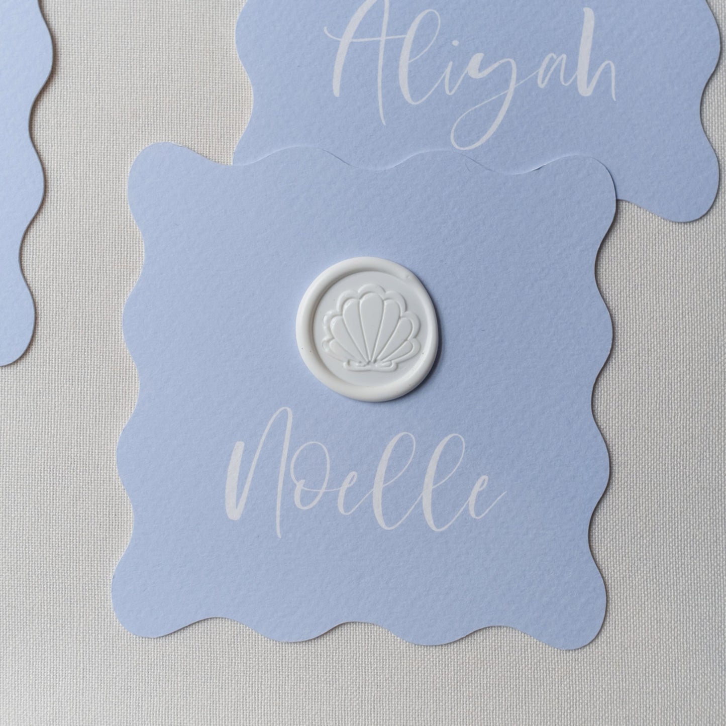 Wavy shaped place card with shell wax seal