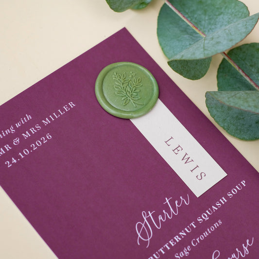 burgundy wedding menu with wax seal and guest name