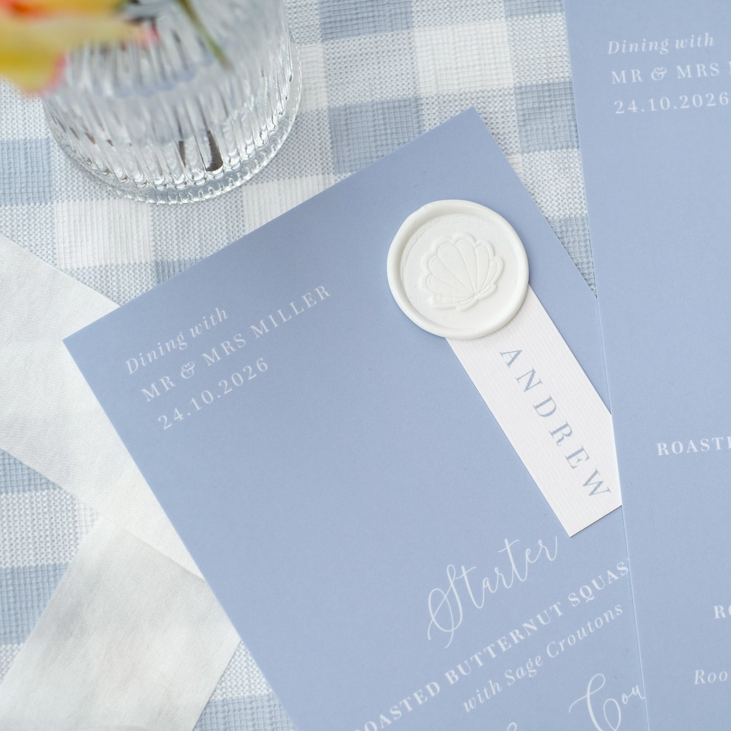 dusty blue wedding menu with wax seal guest name