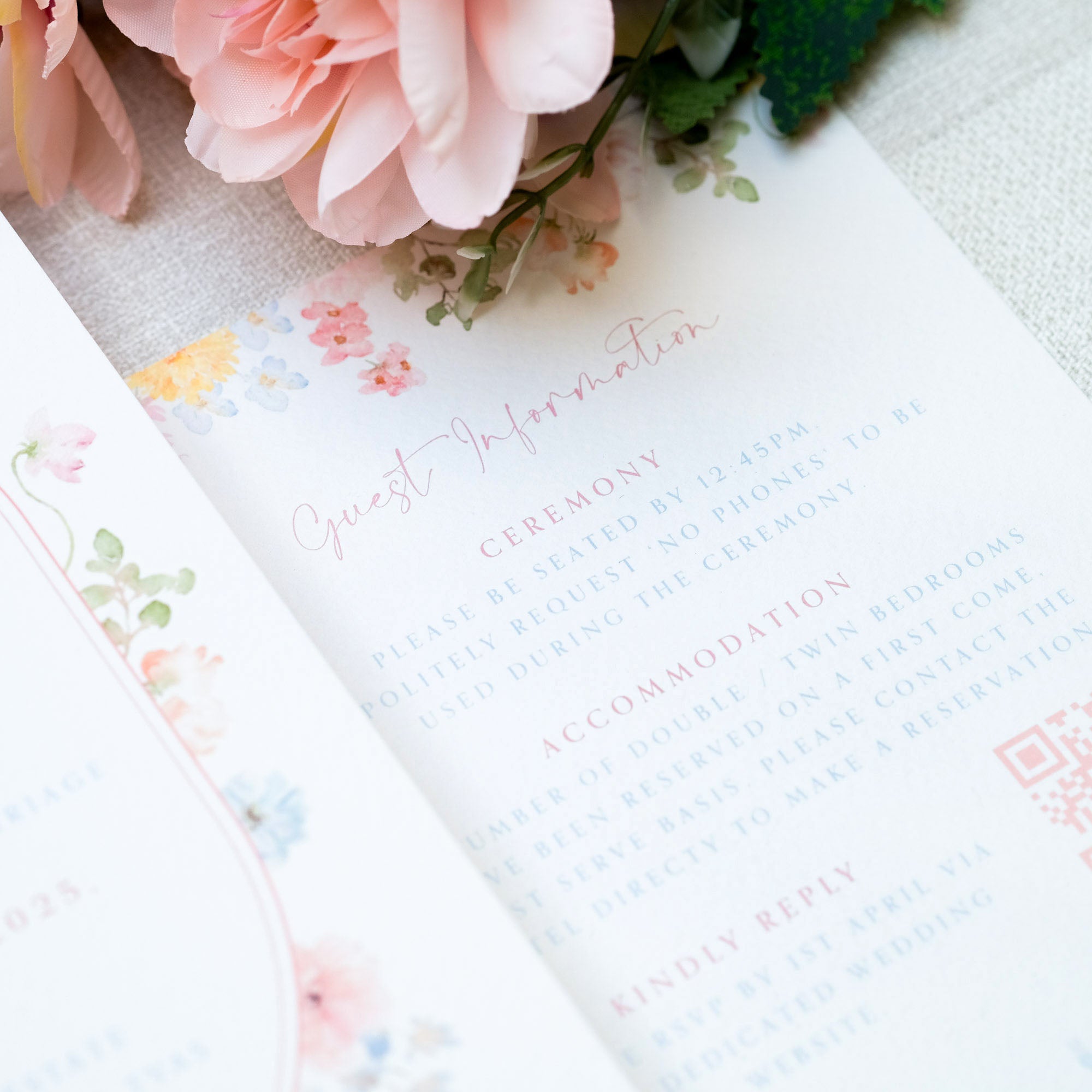 Wedding invitation with information on the ceremony, accommodation, and RSVP with pastel wildflower details