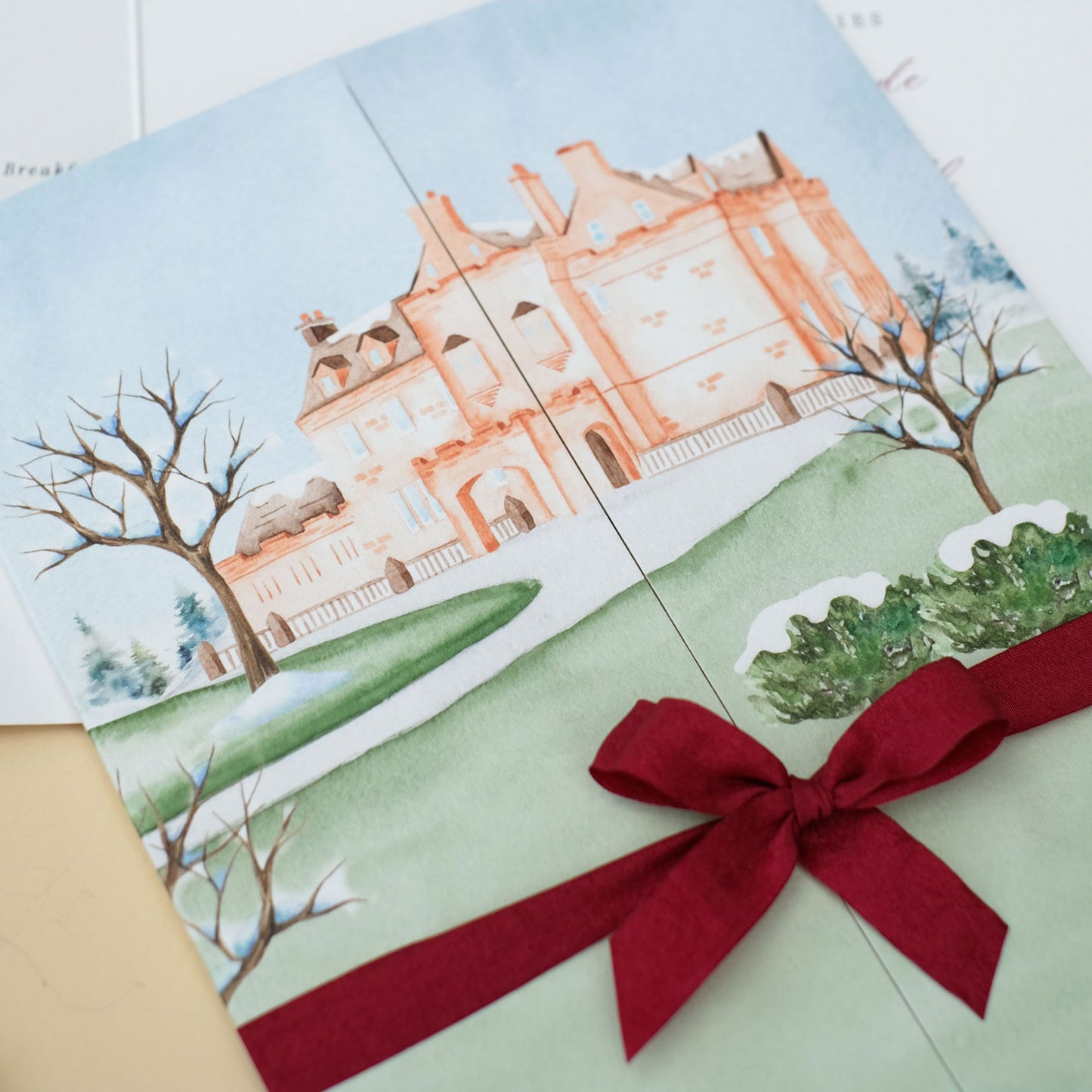 Illustration of Sorn Castle in the snow for winter weddings, folded wedding invitation with ribbon