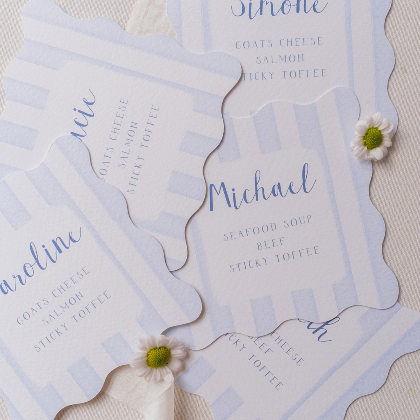 Blue wavy shaped place cards with stripes