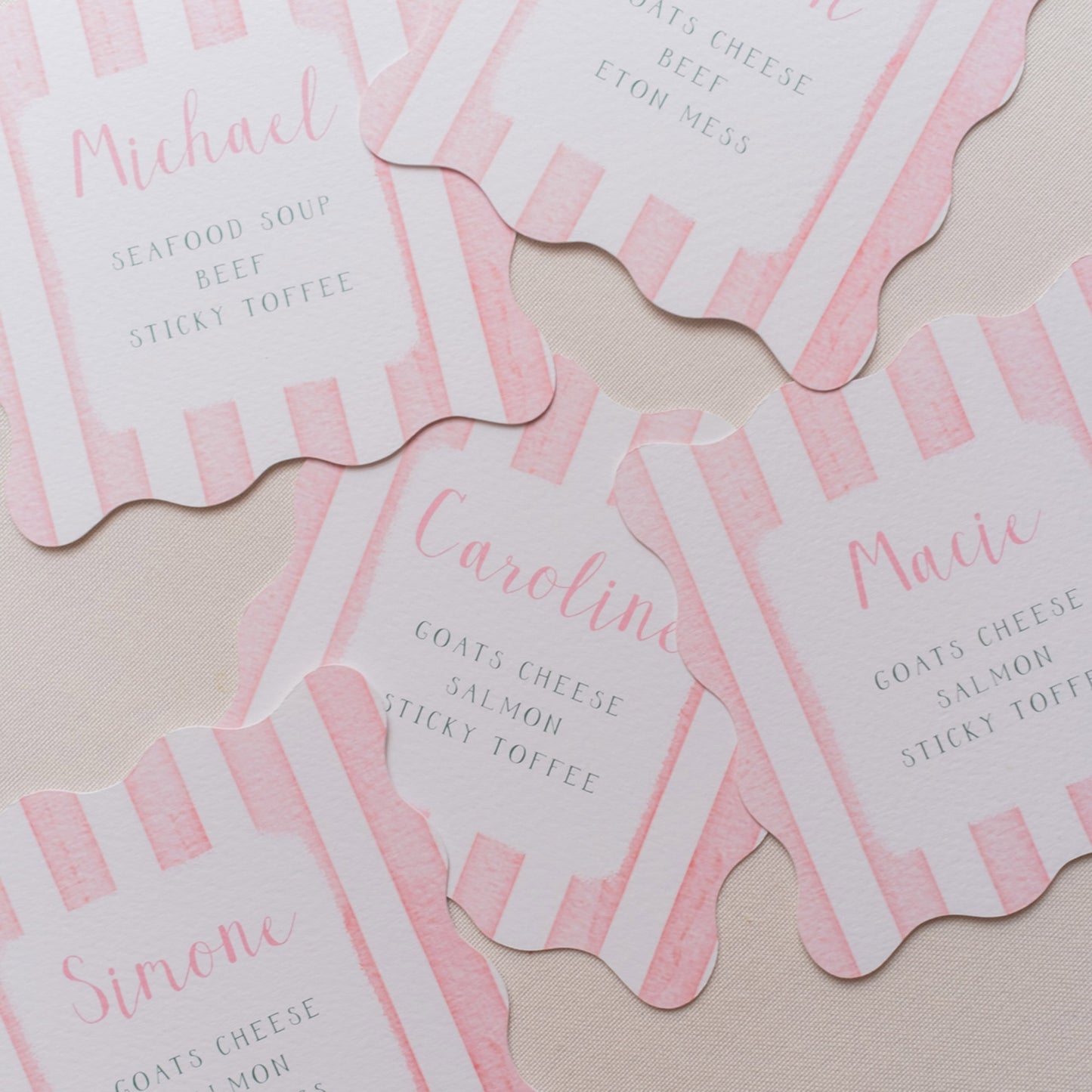 Pink wavy shaped place cards with stripes