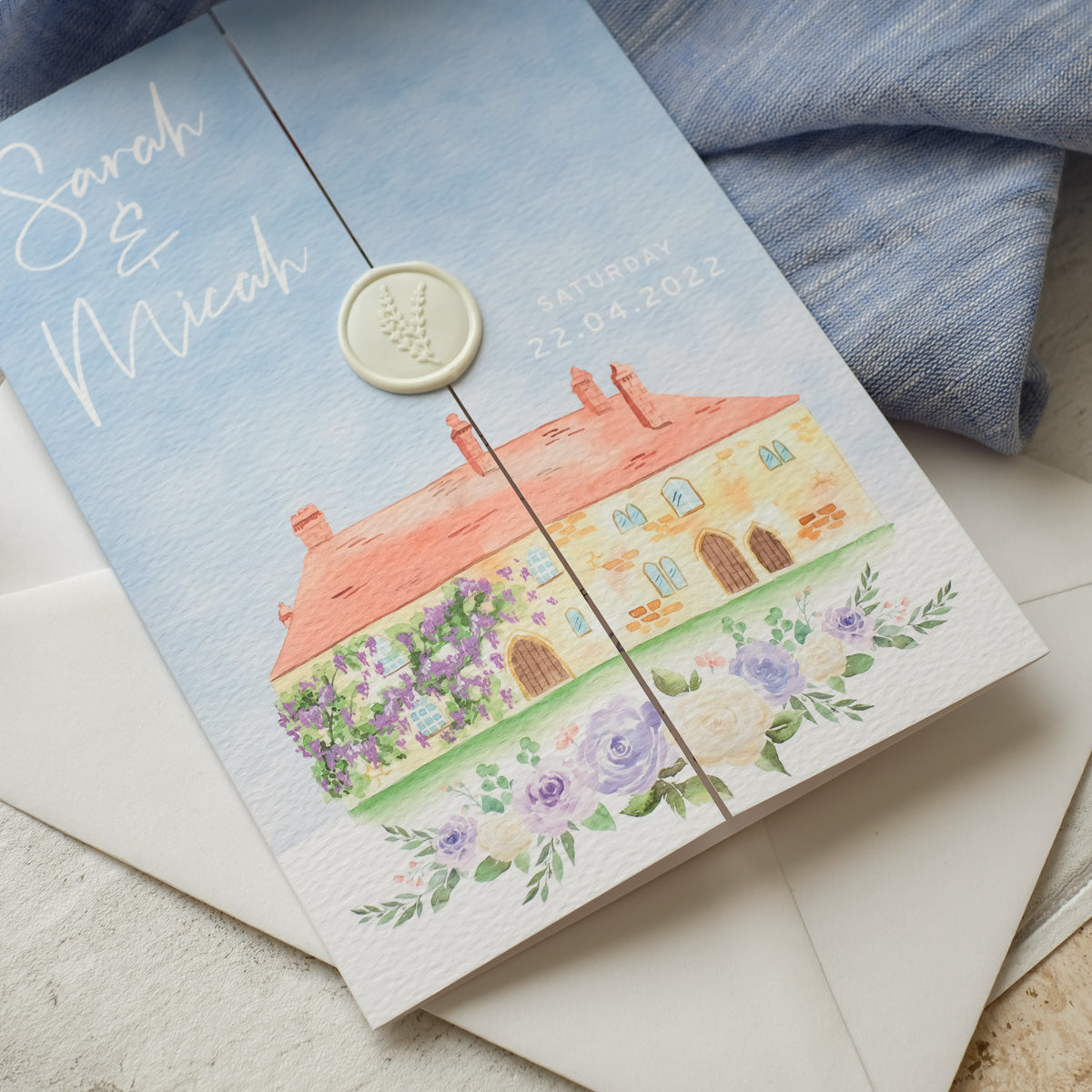 Folded wedding invitation with venue illustration